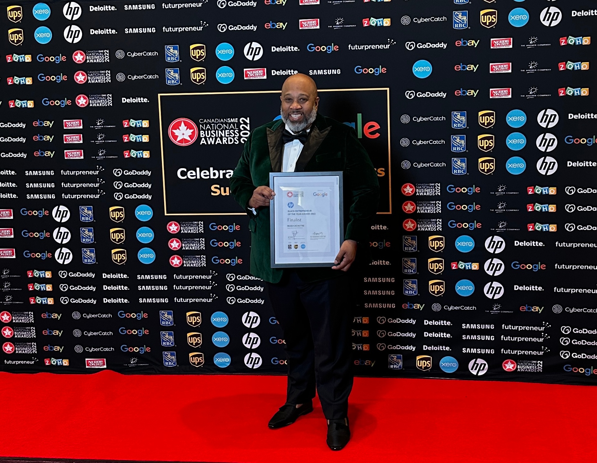 Ross holding his CanadianSME Black Entrepreneur of the Year finalist certificate